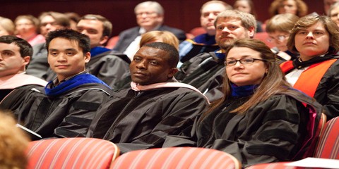 Faculty members in audience listen carefully to the speaker